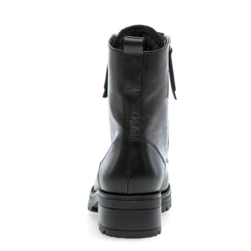 Black leather boot with two gold zippers and laces on a white background Gabor Serve biker boots 72.785 Black
