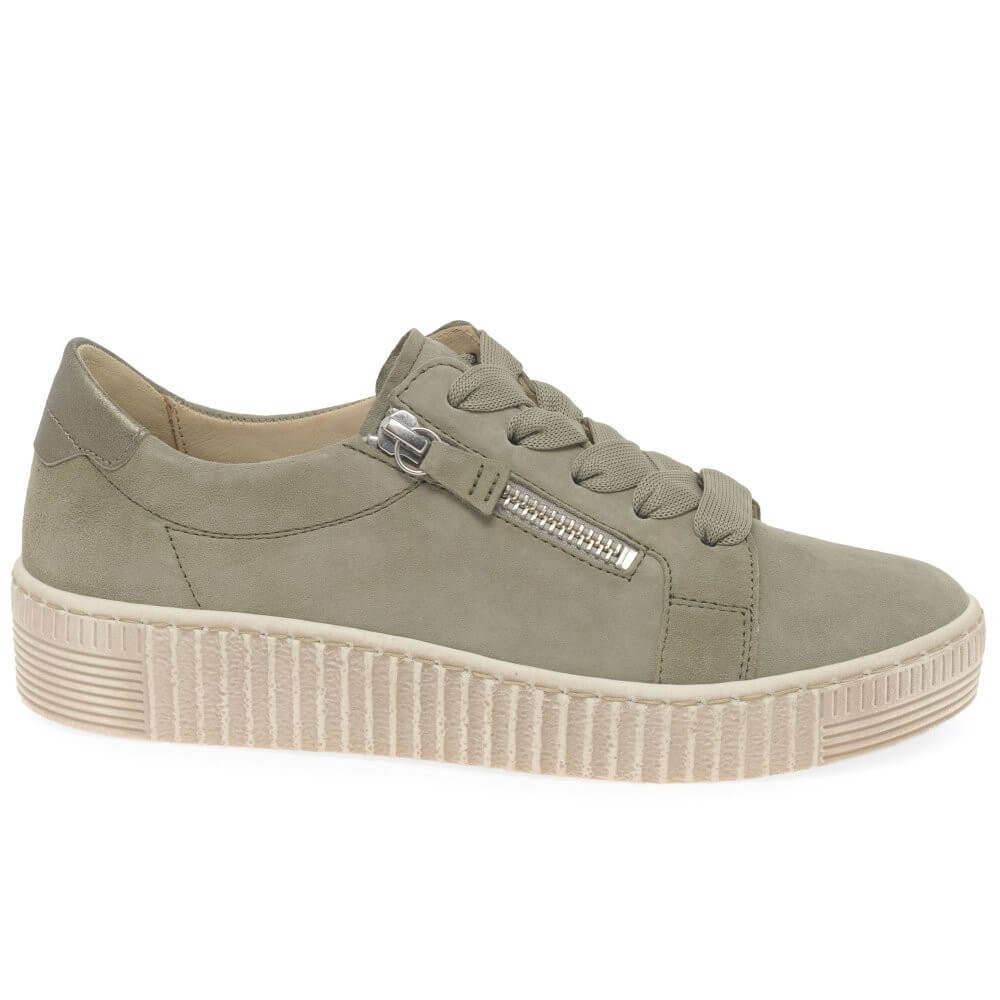Green sneaker with a white sole on a white background