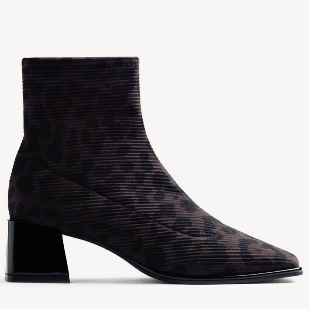A Gioseppo women's ankle boot with a pointed toe, a chunky black block heel, and a ribbed fabric upper featuring a dark brown and black leopard print, shown against a plain white background.