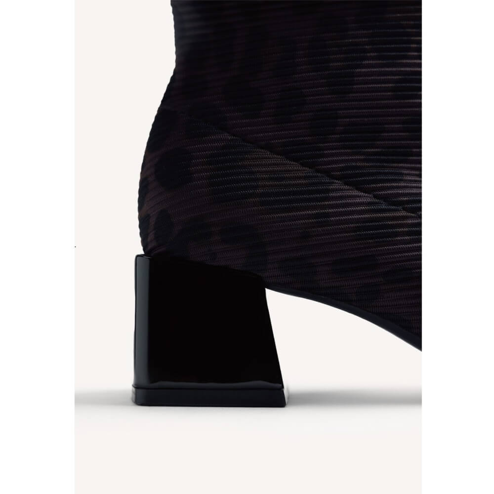 Close-up of a Gioseppo black ankle boot with a textured, ribbed fabric upper and a glossy block heel, shown against a plain off-white background.