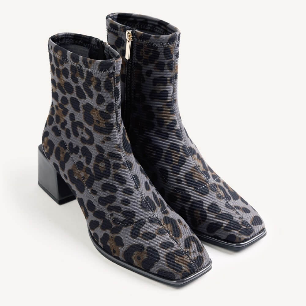 A pair of Gioseppo women's ankle boots featuring a grey ribbed fabric with a black and brown leopard print, square toes, and low block heels, shown on a light grey background.