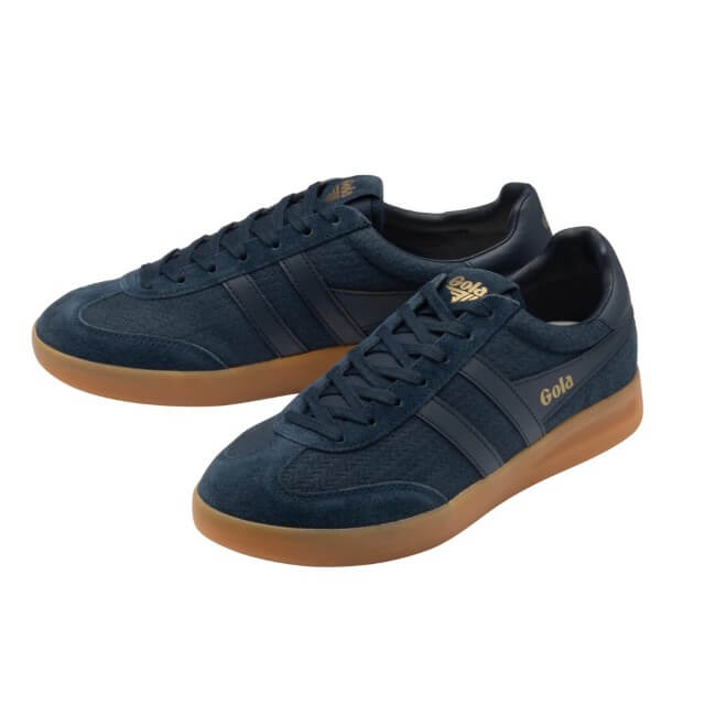 A pair of navy blue suede and mesh low-top sneakers with dark navy side stripes, gold 'Gola' branding on the side and tongue, and gum brown soles, shown on a plain white background.