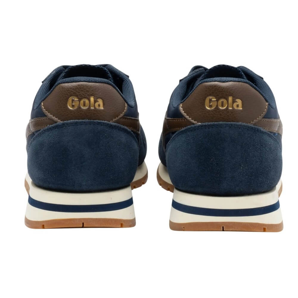 A pair of navy blue suede and leather sneakers shown from the back, featuring brown leather heel tabs with the brand name 'Gola' in gold lettering, a cream midsole with a navy stripe, and a brown gum outsole.