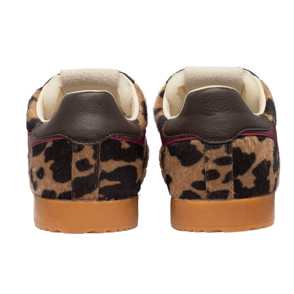 A pair of Gola low-top sneakers shown from the back, featuring a brown and black leopard print upper, dark brown leather heel tabs, cream-colored lining, and gum brown soles.