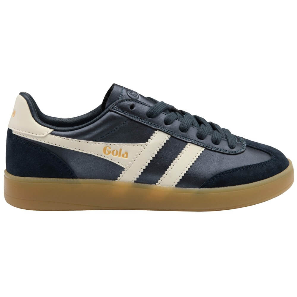 A low-top sneaker in navy blue leather and suede with cream side stripes, a gold 'Gola' logo, and a gum sole, shown from a side profile on a white background.