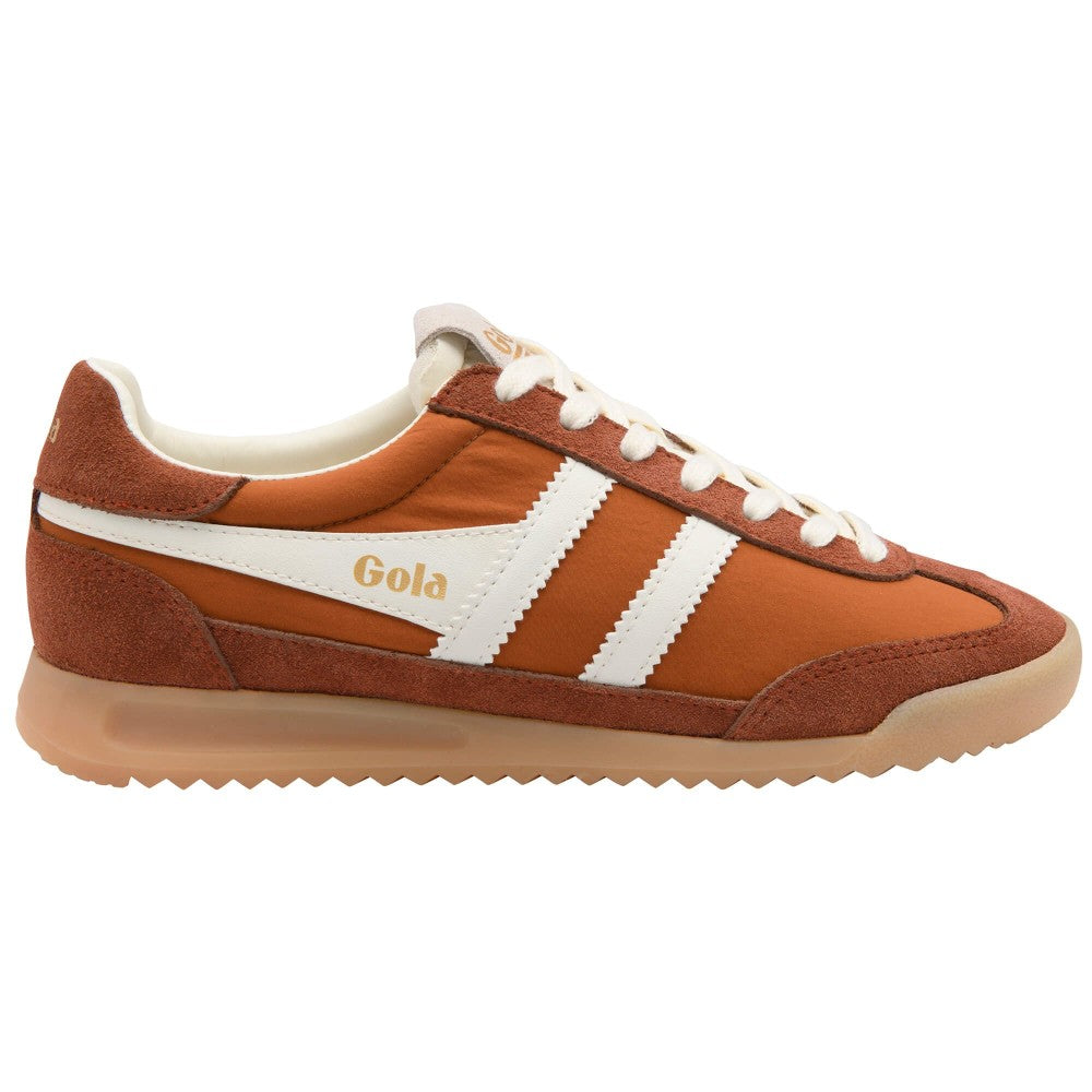 A Gola classic low-top sneaker in rust orange suede and mesh, featuring three white side stripes, a gold 'Gola' logo, white laces, and a gum sole.