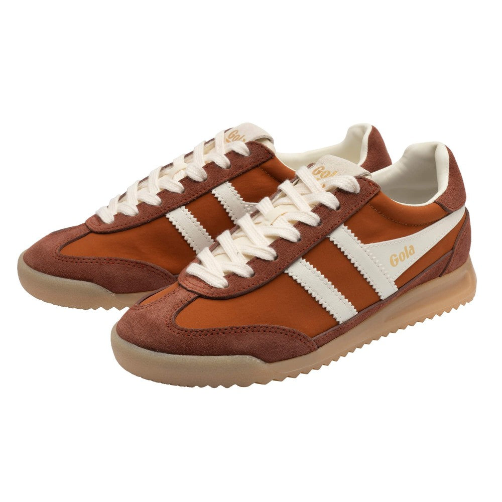 A pair of retro-style low-top sneakers in brown suede and leather, featuring off-white side stripes, off-white laces, and a beige gum sole, with 'Gola' printed in gold on the side.