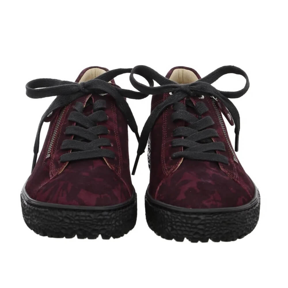 A pair of Hartjes low-top sneakers in a deep burgundy and black floral patterned suede, featuring a side zipper, black laces, and a chunky black textured sole.