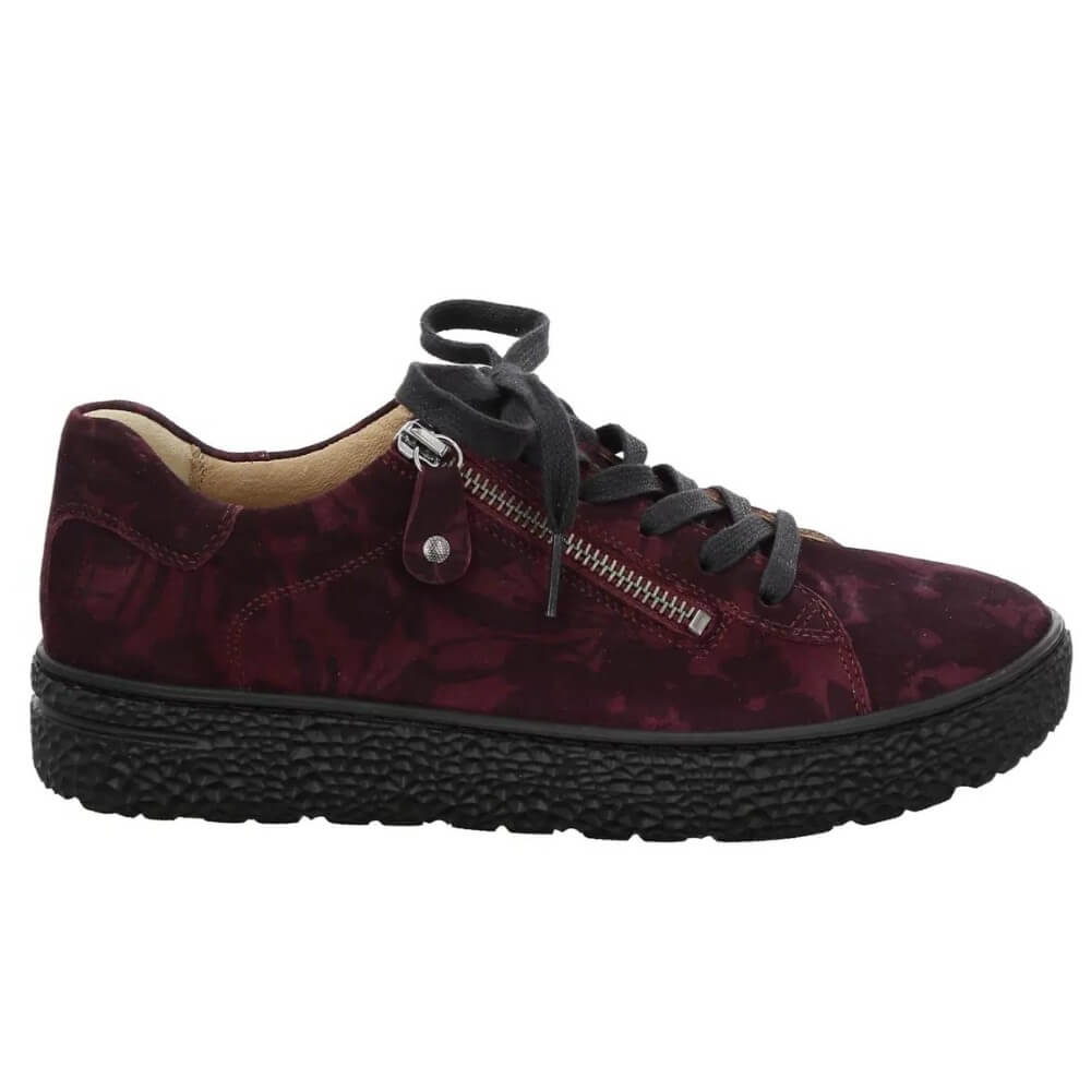 A Hartjes low-top sneaker in a deep burgundy and black floral patterned suede, featuring a side zipper, black laces, and a chunky black textured sole.
