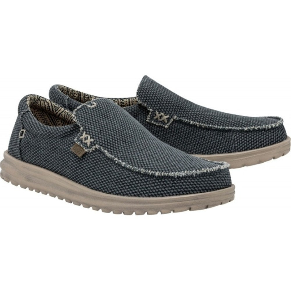 HeyDude Navy slip-on shoes with a textured pattern on a white background