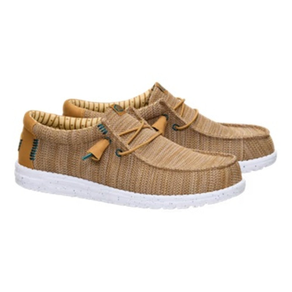 Pair of Heydude brown casual shoes with white soles on a white background