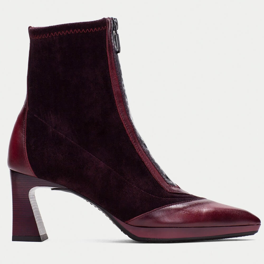 Maroon ankle boot with a block heel on a light gray background