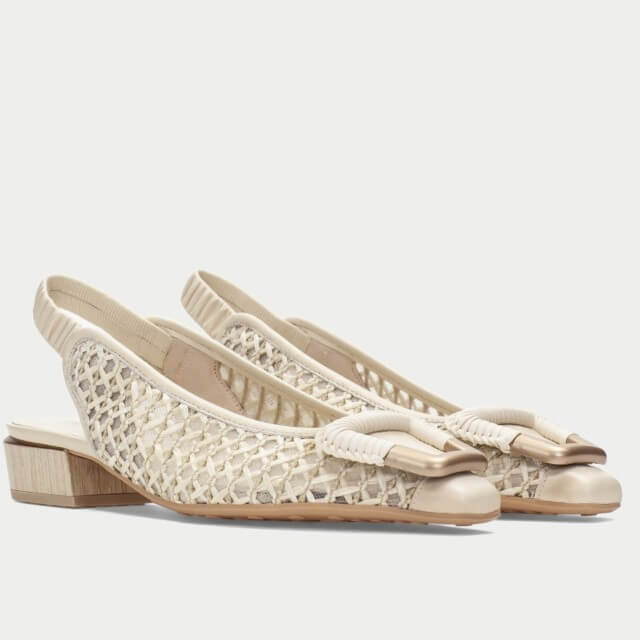 Pair of Hispanitas Beige sandals with  raffia lace detailing on a white background