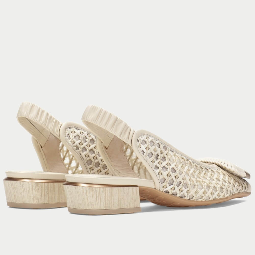 Pair of Hispanitas Beige sandals with  raffia lace detailing on a white background