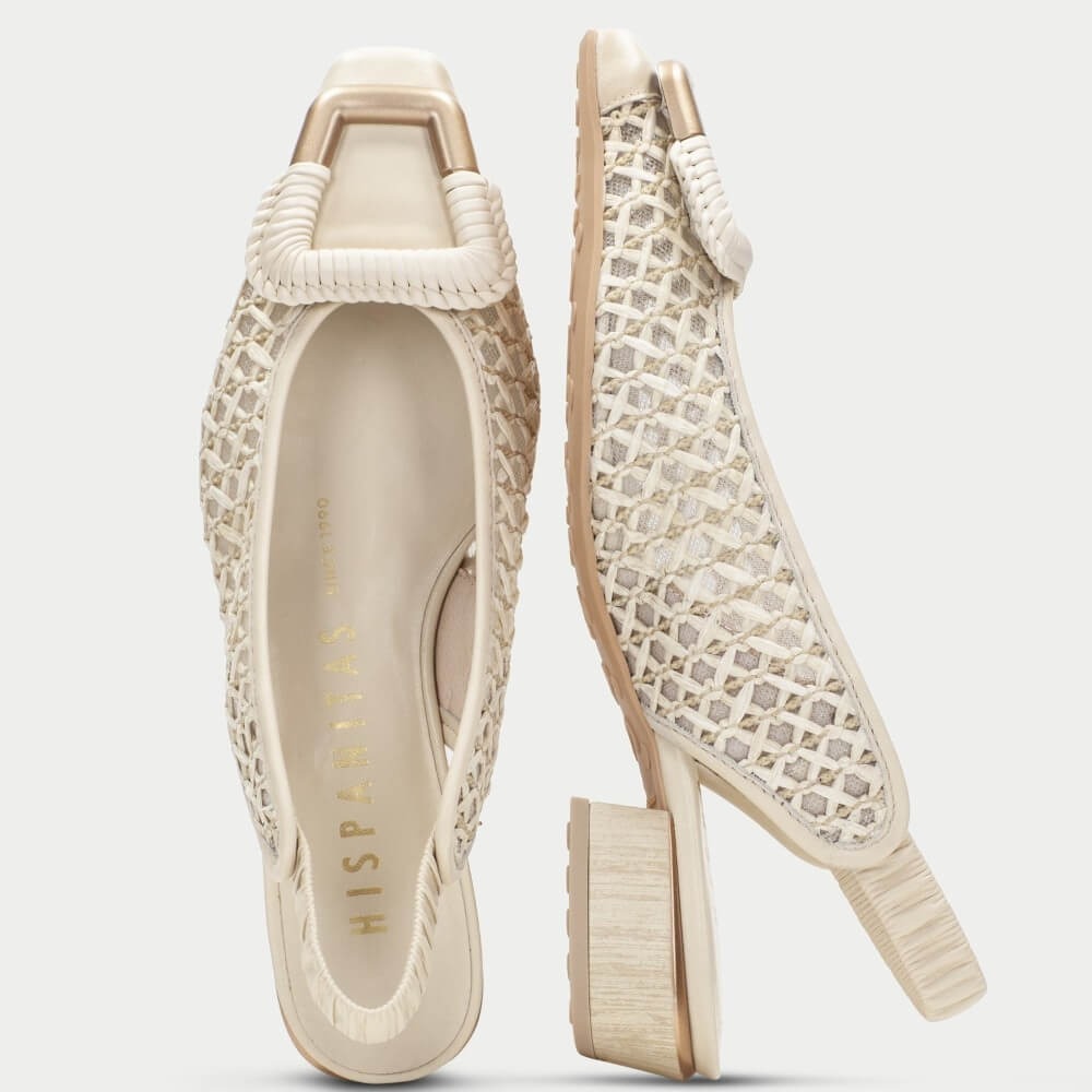 Pair of Hispanitas Beige sandals with  raffia lace detailing on a white background