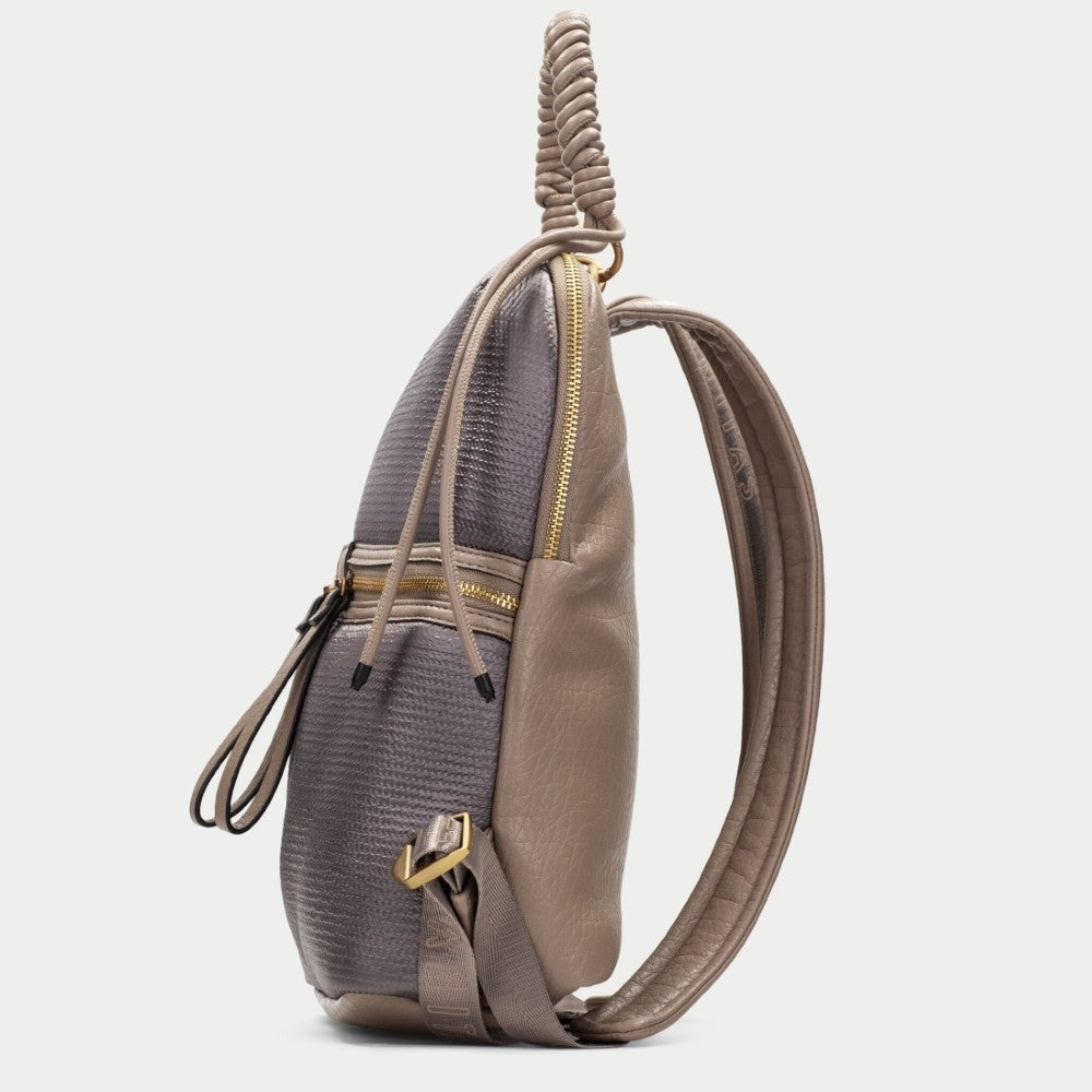 A side-profile view of a slouchy shoulder bag featuring a textured gray-green python-patterned upper half and smooth taupe-brown leather on the lower half and strap, with gold-tone hardware.