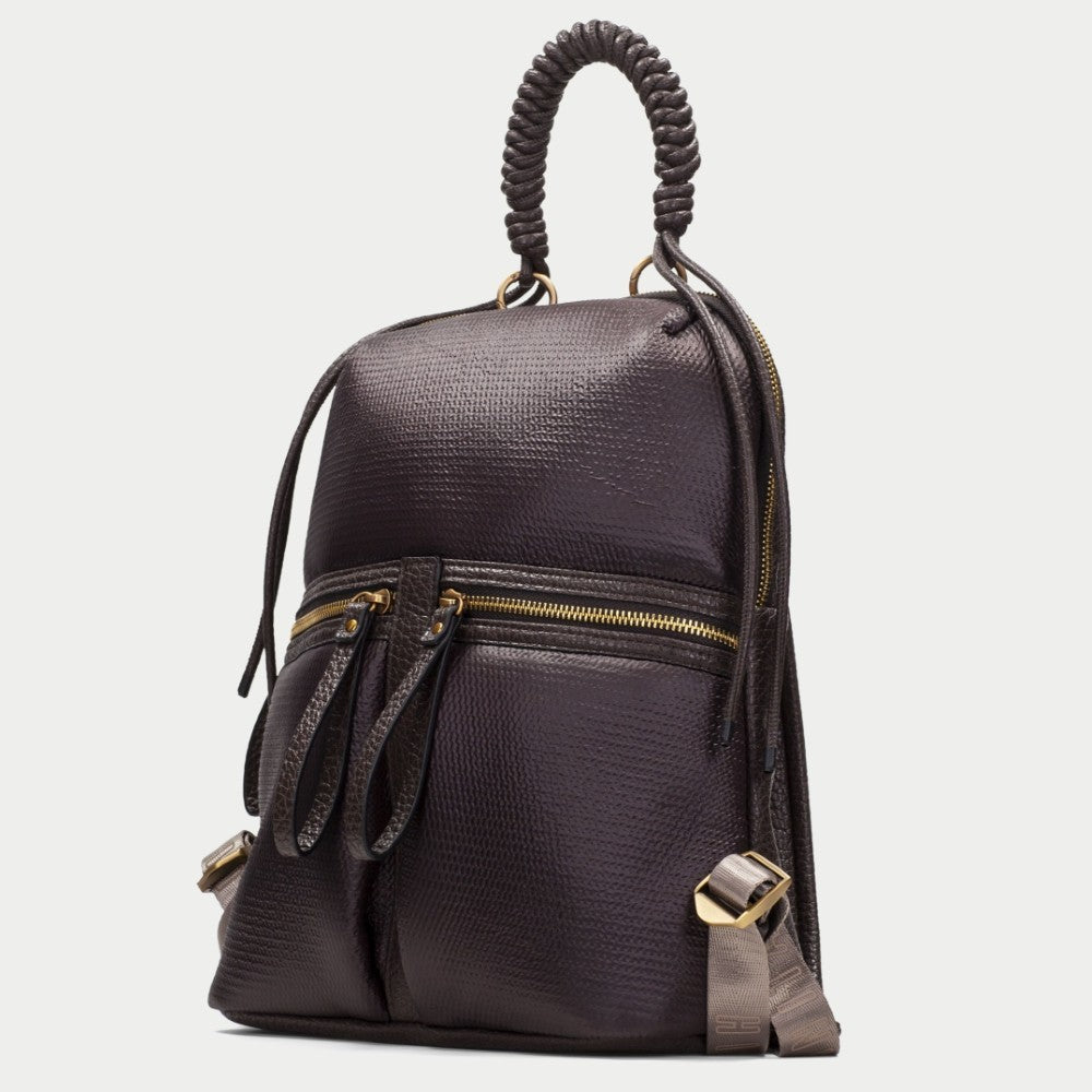 A Hispanitas dark brown textured  backpack with a braided top handle, gold-tone zippers, and grey  side accents, shown against a light grey background.