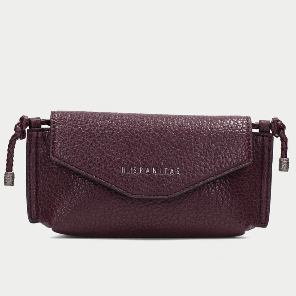 A burgundy pebbled PU leather clutch bag with a flap closure and braided strap details, featuring the brand name 'HISPANITAS' in  lettering on the front, set against a plain light gray background.