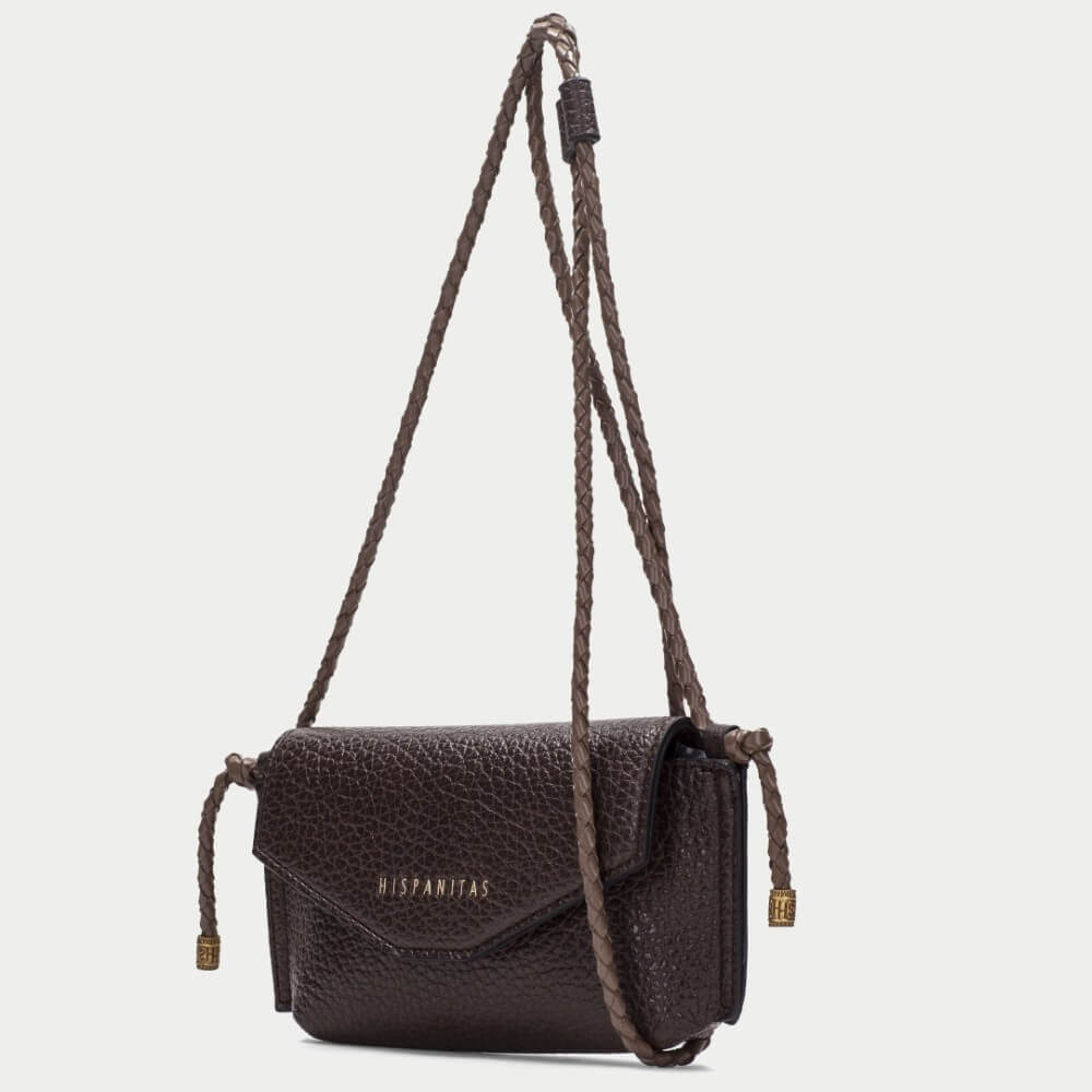 A dark brown pebbled  crossbody bag with a flap closure and gold-tone 'HISPANITAS' branding, shown against a light grey background.