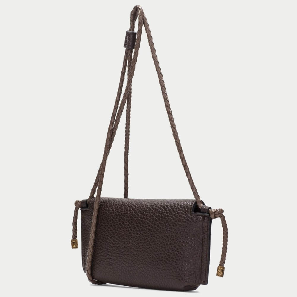 A dark brown pebbled  crossbody bag with a flap closure and gold-tone 'HISPANITAS' branding, shown against a light grey background.