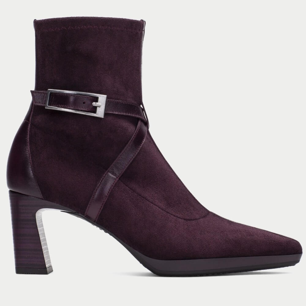 A Hispanitas Bordeaux suede ankle boot with a block heel, a decorative side strap, and a silver buckle, shown from a side profile on a light grey background.