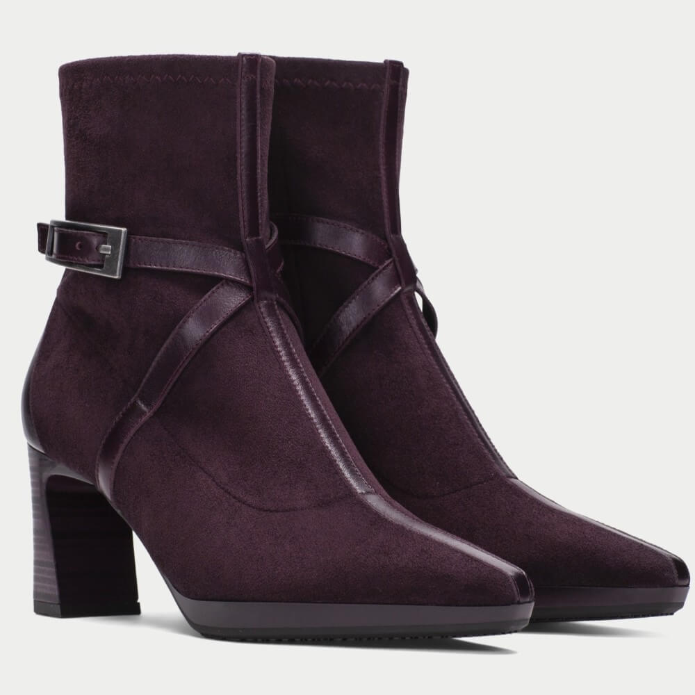 A pair of Hispanitas Bordeaux suede ankle boots with pointed toes, block heels, and decorative side straps with a grey silver buckle, shown against a light grey background.