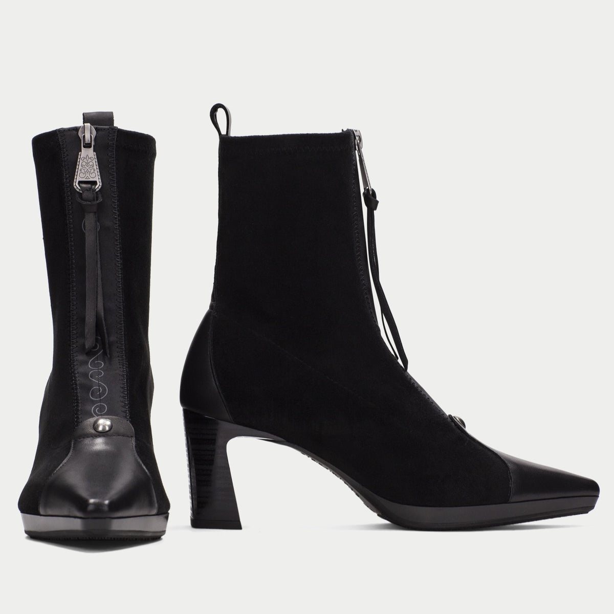 A pair of black ankle boots with a pointed toe, block heel, and side zipper, shown from both front and side angles on a light gray background.