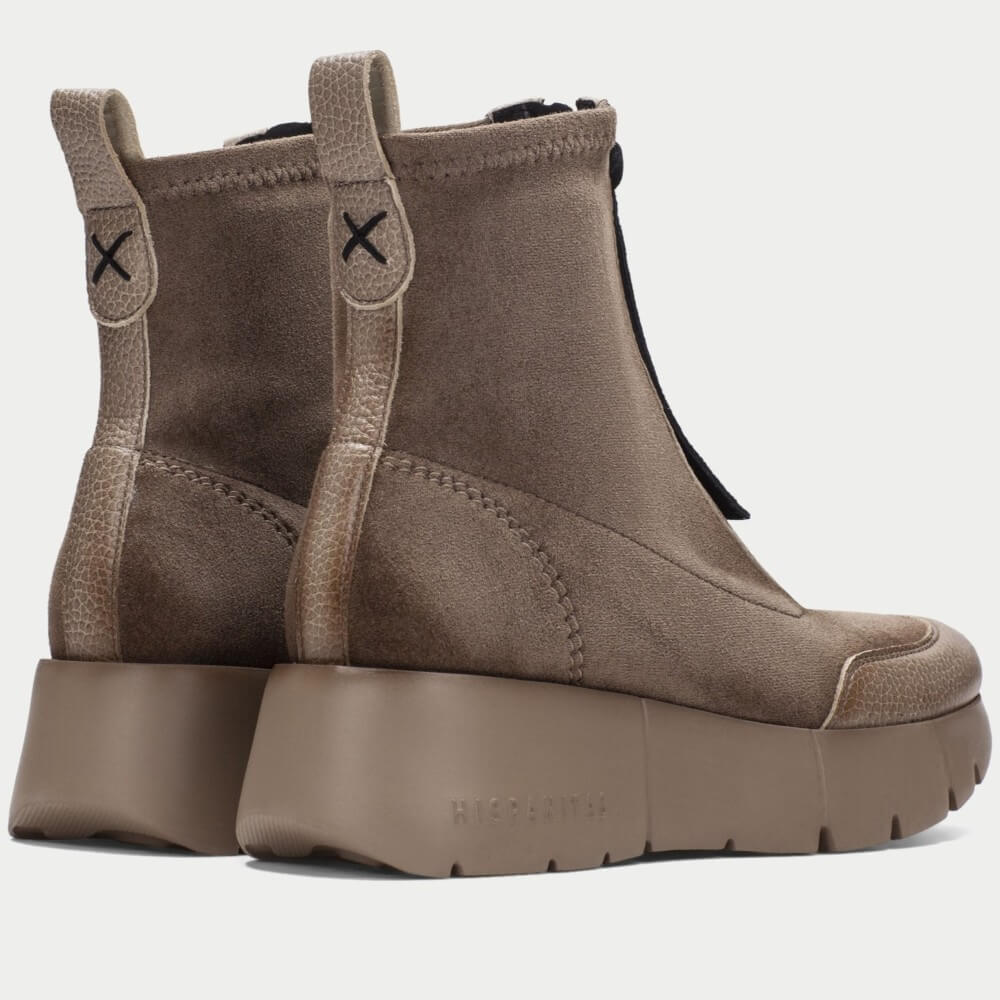 A pair of Hispanitas ankle boots in a taupe brown colour, featuring a pebbled leather upper, a front zipper with brown pull tabs, and a chunky lug sole.