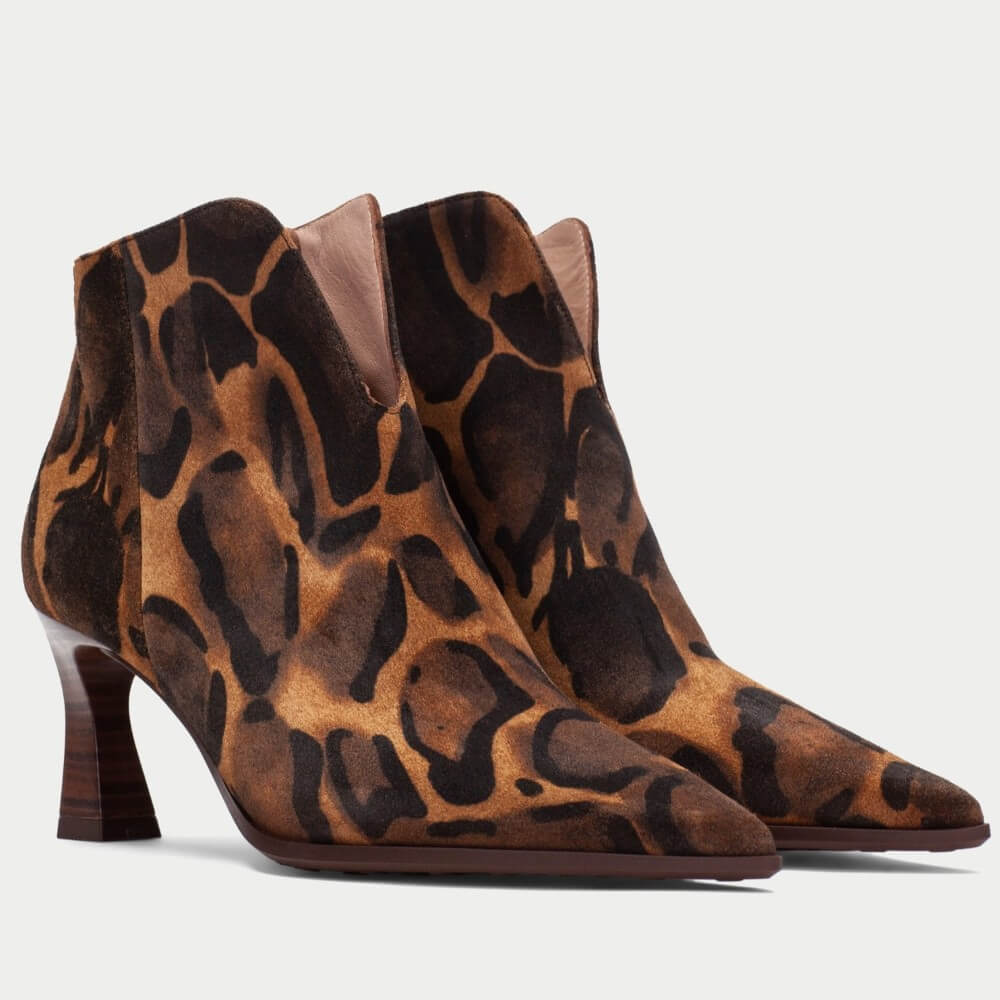 A pair of Hispanitas pointed-toe ankle boots with a brown and black Giraffe leopard print pattern, featuring a low block heel, shown against a light grey background.