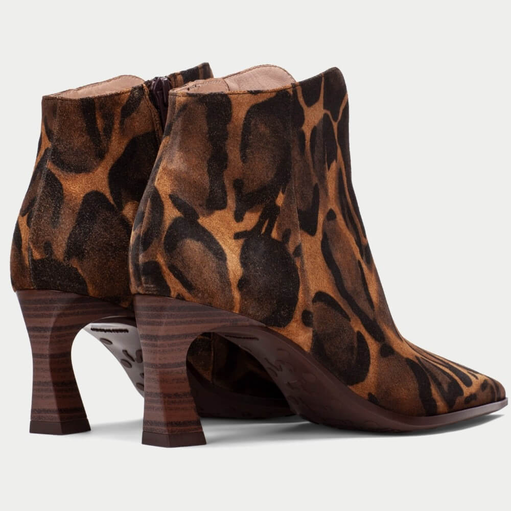 A pair of Hispanitas pointed-toe ankle boots featuring a brown and black leopard print pattern, with a distinctive dark brown block heel, shown against a light grey background.