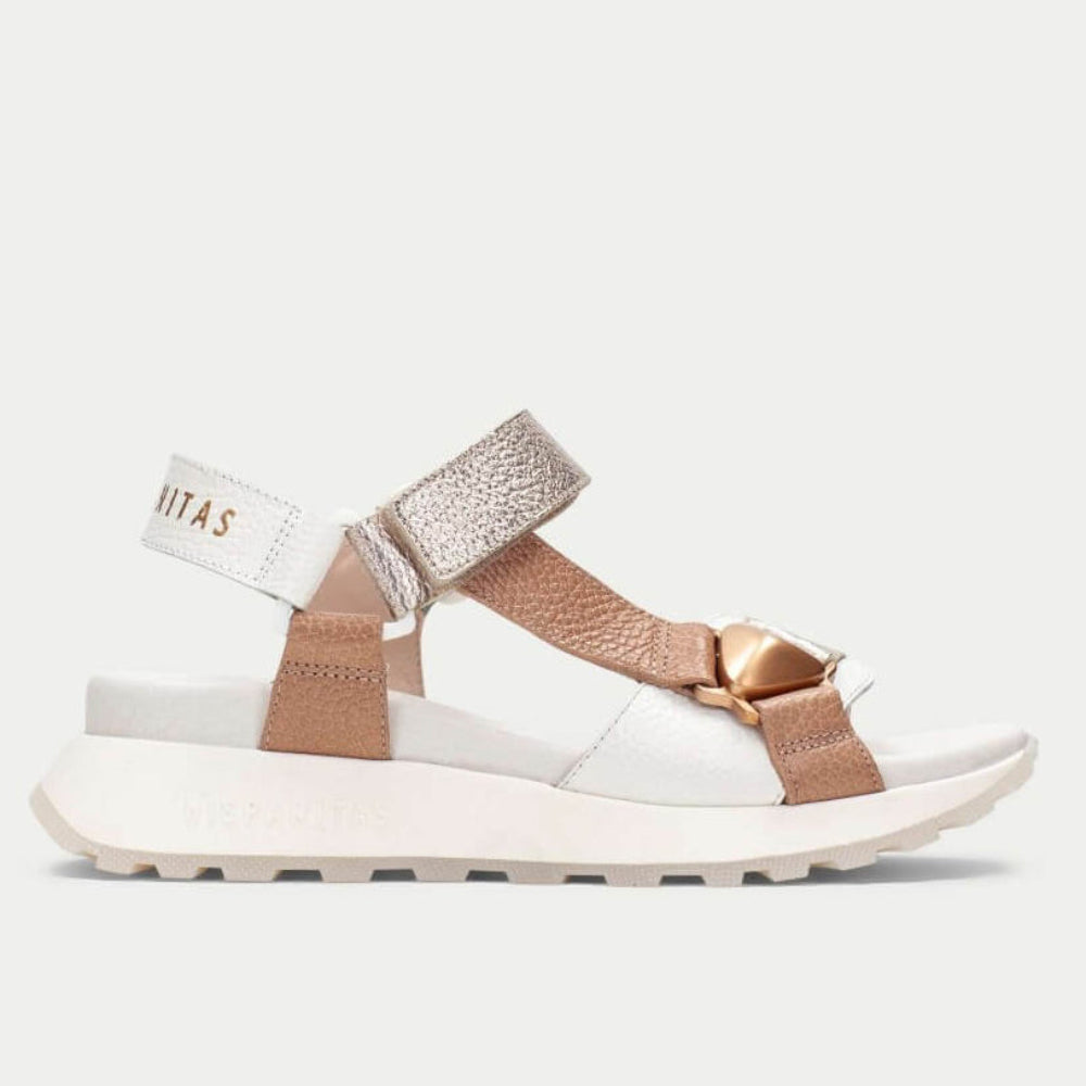 White and brown sandal with metallic accents on a white background