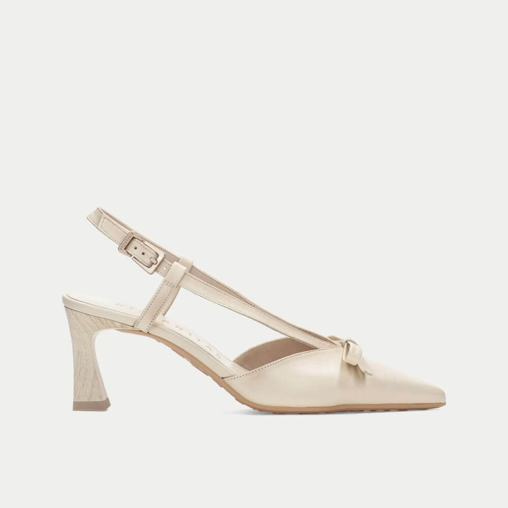 Beige high-heeled shoe with a strap on a light gray background