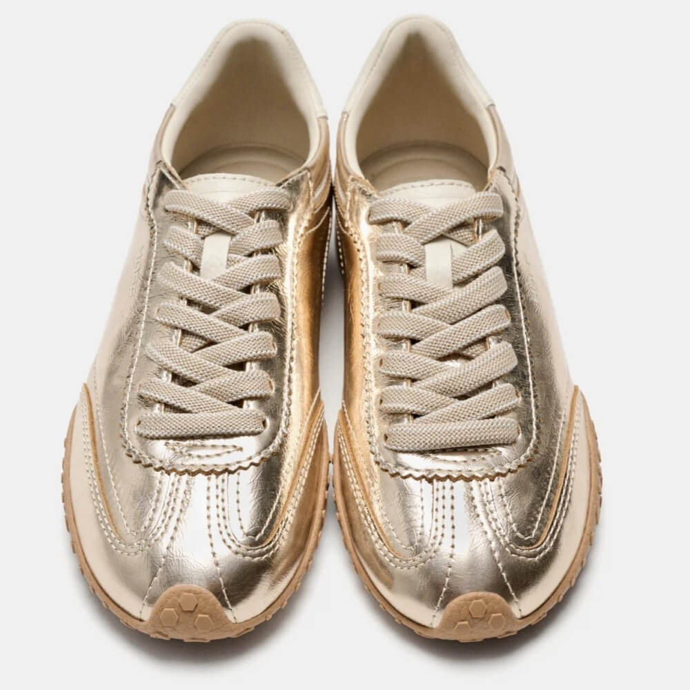 A pair of Hoff metallic gold low-top sneakers with beige laces and beige rubber soles, shown from a top-down view on a light gray background.
