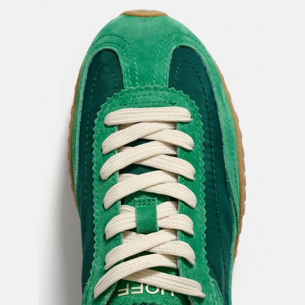 Green sneaker with white laces on a light gray background Hoff Bridge MK II Green
