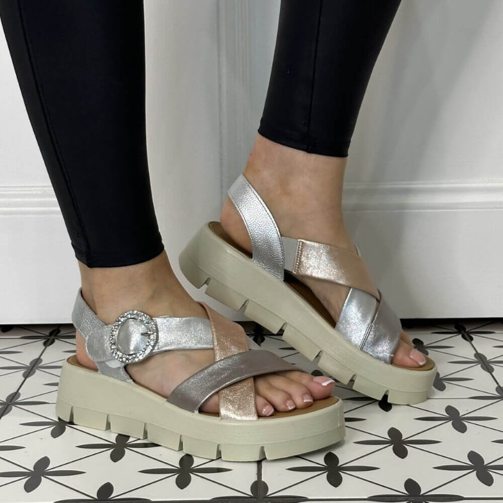 Igi & Co Gold and Silver platform sandals worn with black leggings on a patterned floor.