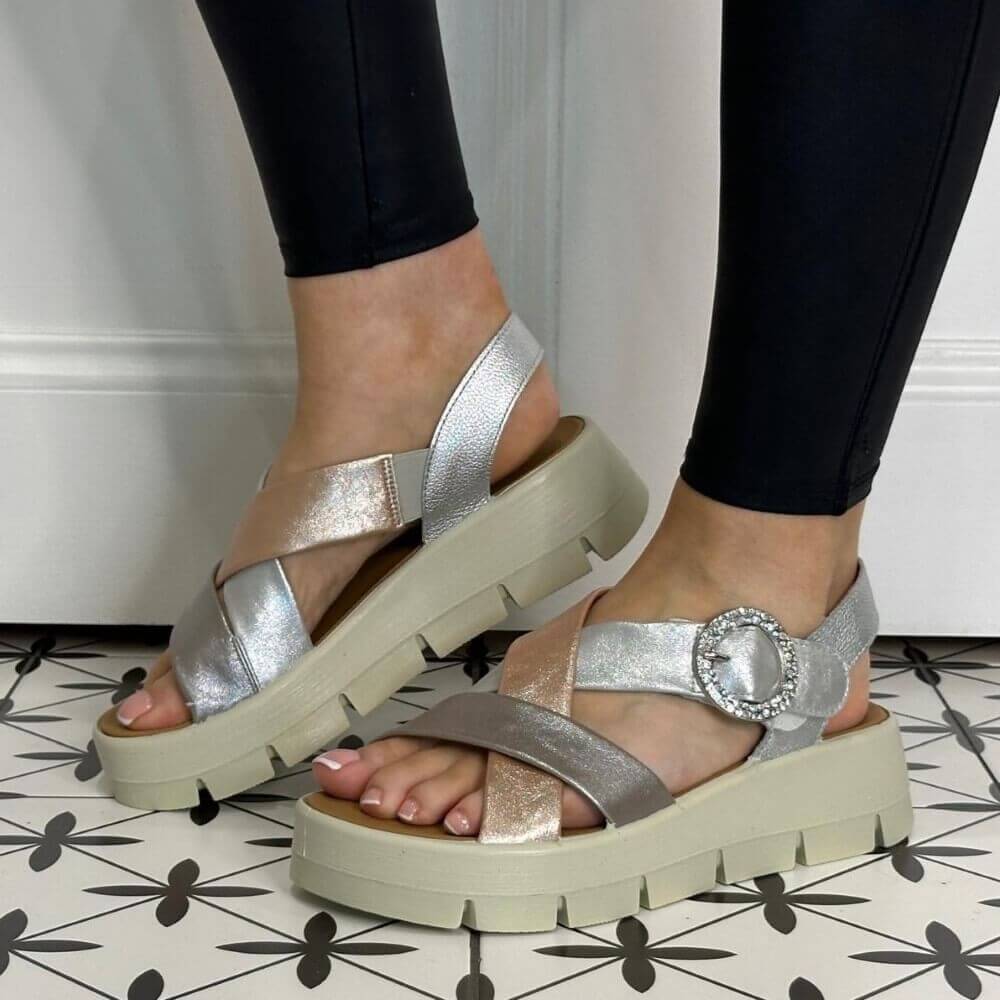 Igi & Co Gold and Silver platform sandals worn with black leggings on a patterned floor.