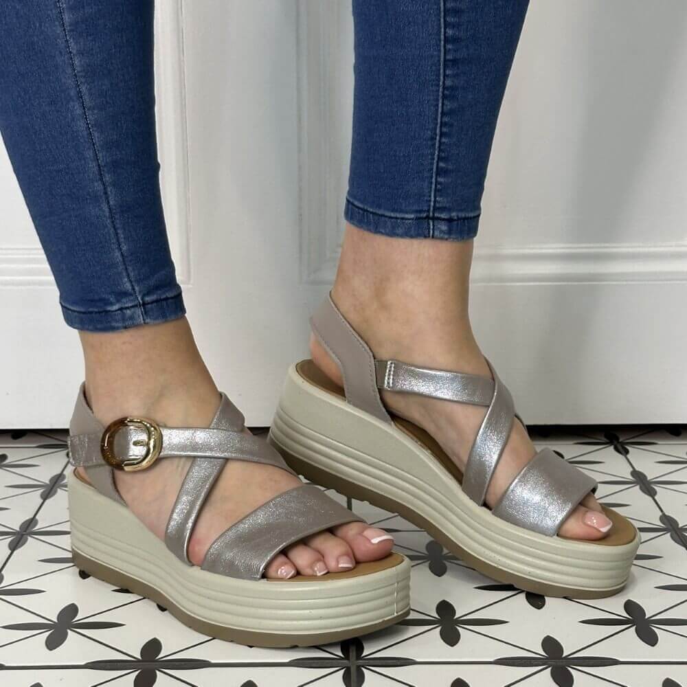Igi & Co Silver sandals with a platform worn by a person on a patterned floor.