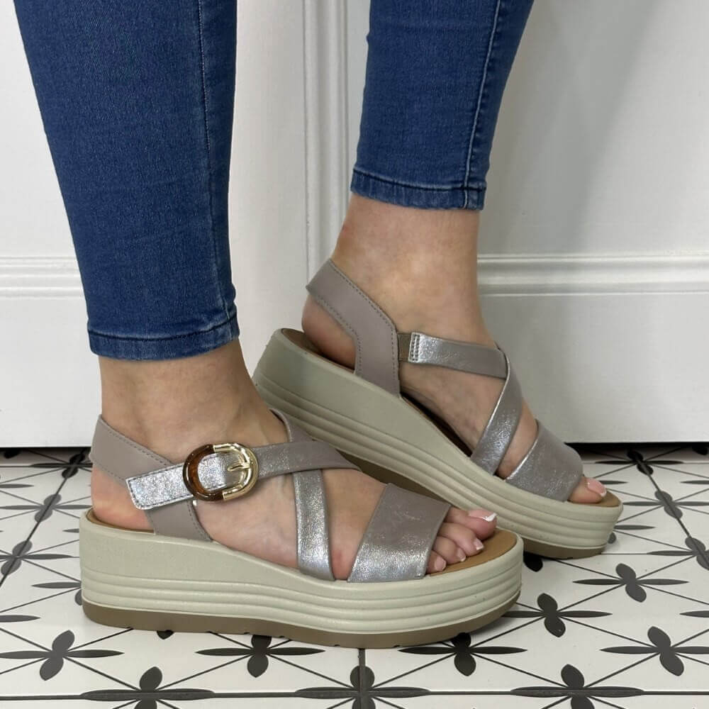 Igi & Co Silver sandals with a platform worn by a person on a patterned floor.