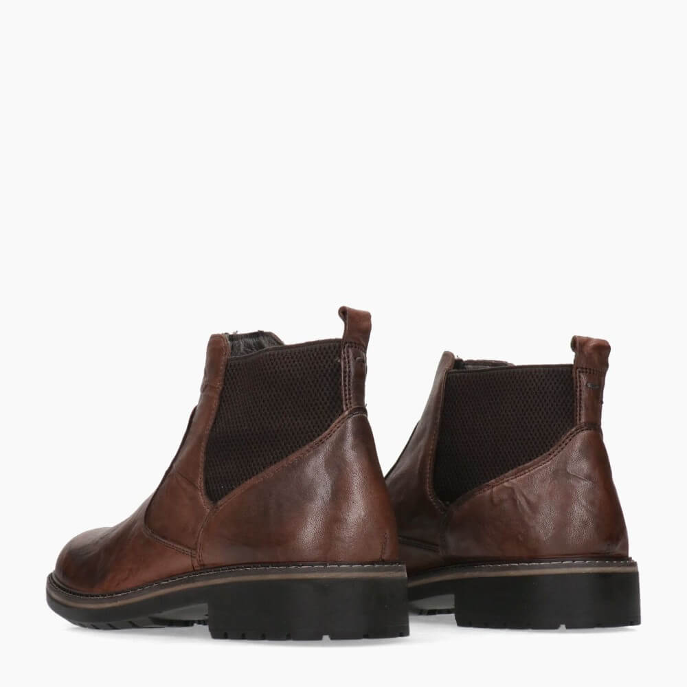 Pair of brown leather boots on a white background