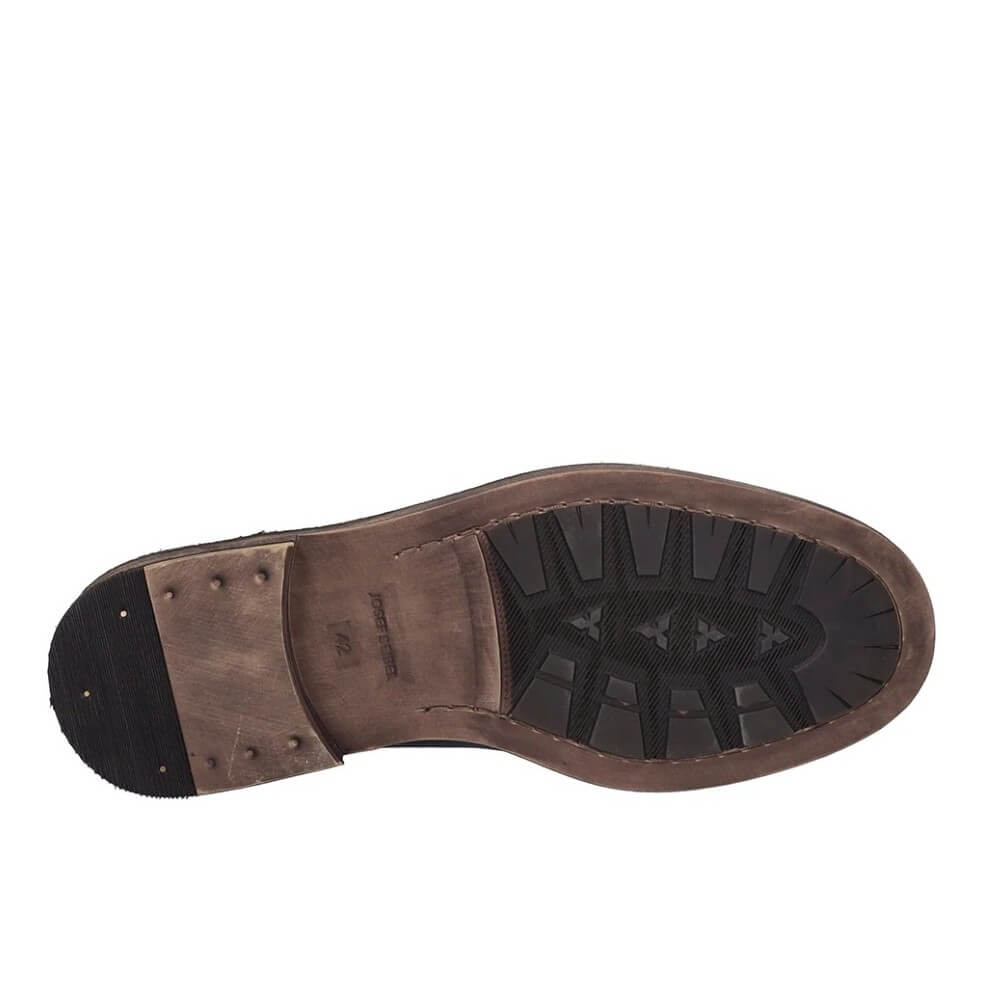 The outsole of a brown leather boot, showing a black treaded rubber bottom and a matching brown footbed, photographed against a solid white background.