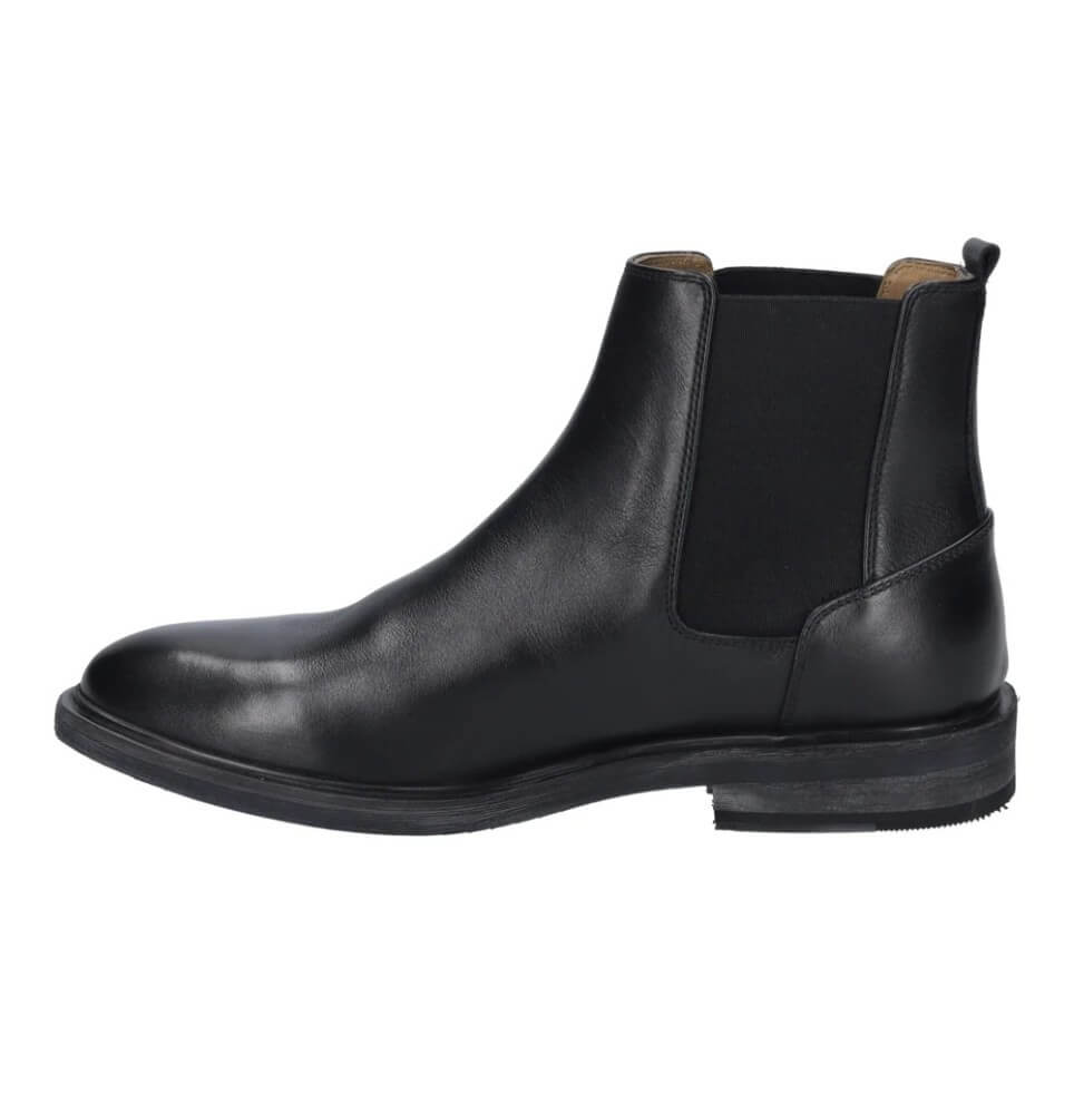 A Josef Seibel black leather Chelsea boot with a black elastic side panel, shown in a side profile view against a plain white background.