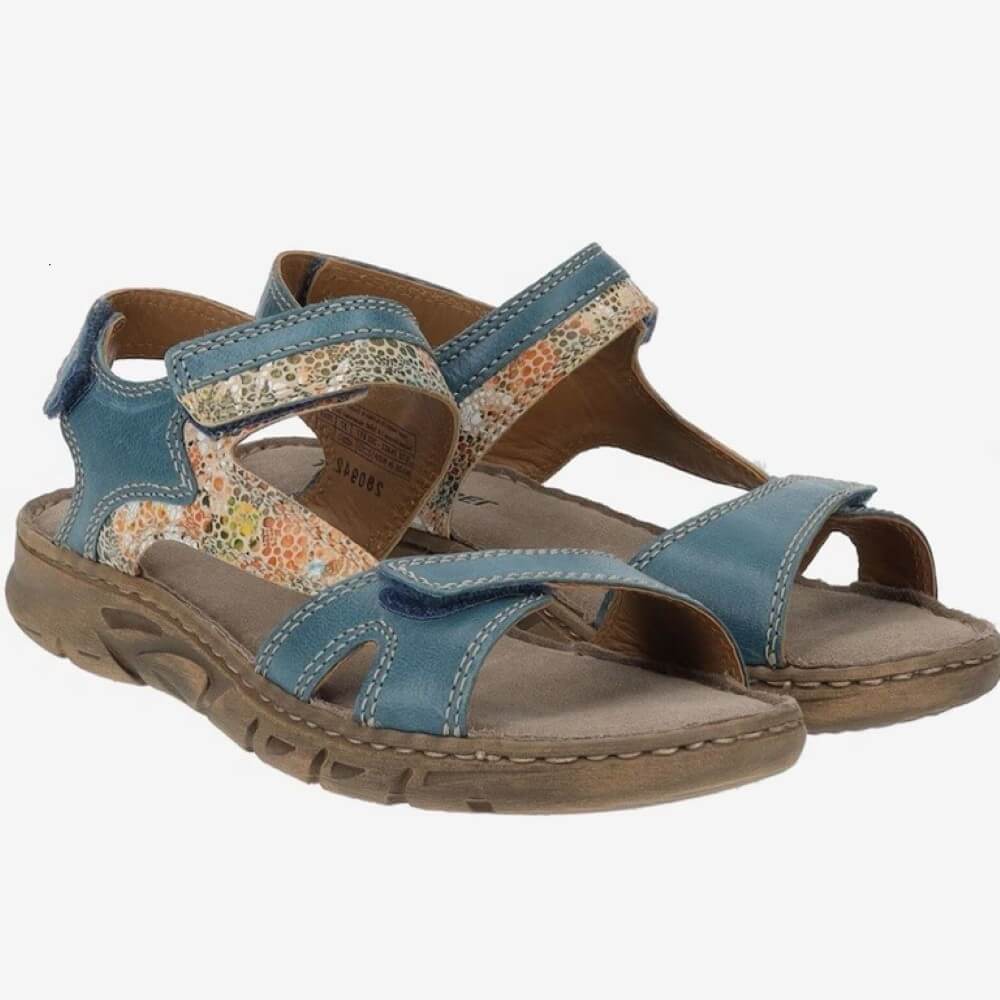 Pair of Josef Seibel blue sandals with floral pattern on a white background