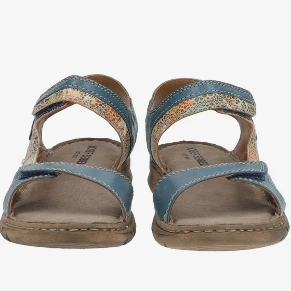 Pair of Josef Seibel blue sandals with floral pattern on a white background