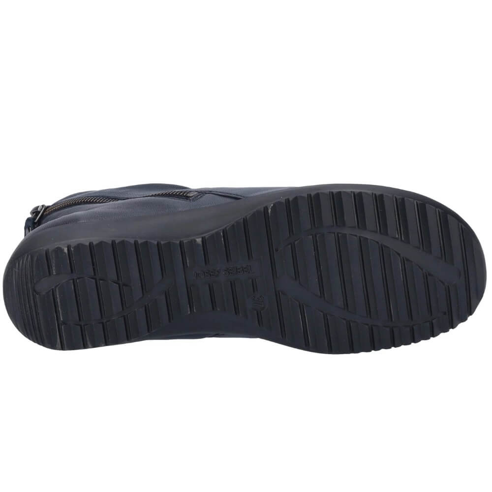 A close-up view of the textured black rubber outsole of a boot, showing tread patterns and a molded logo, on a plain white background.
