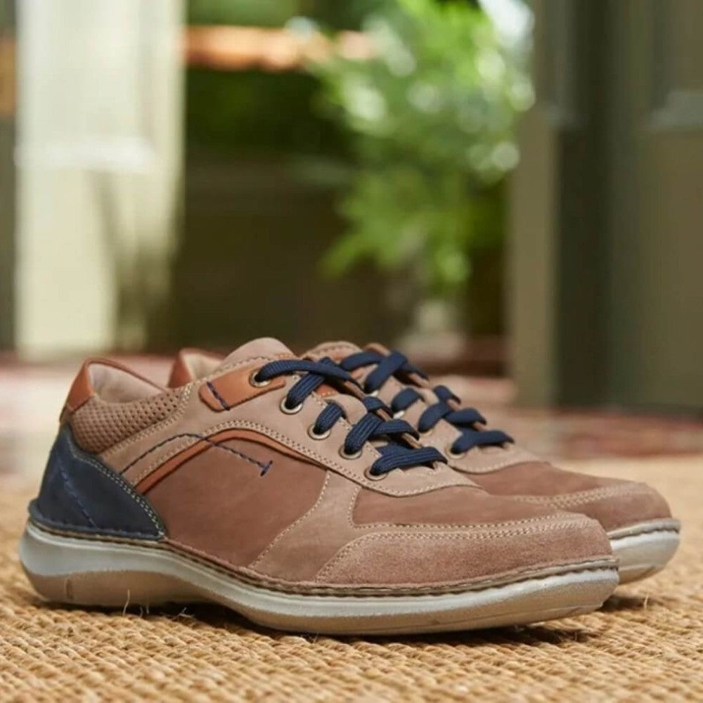 Josef Seibel Brown and blue sneakers on a woven surface with a blurred green background