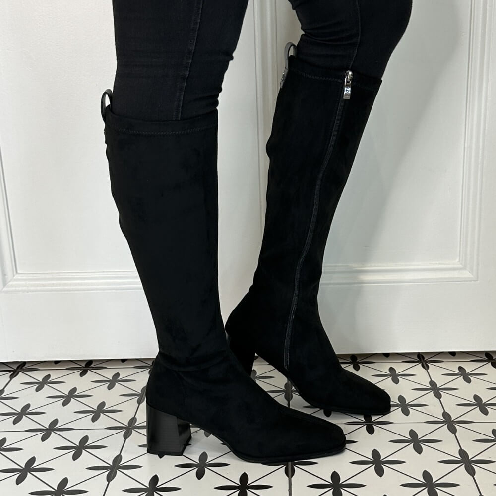 Person wearing black knee-high boots on a patterned floor. LODI A-HALBOR Knee High Boot Black