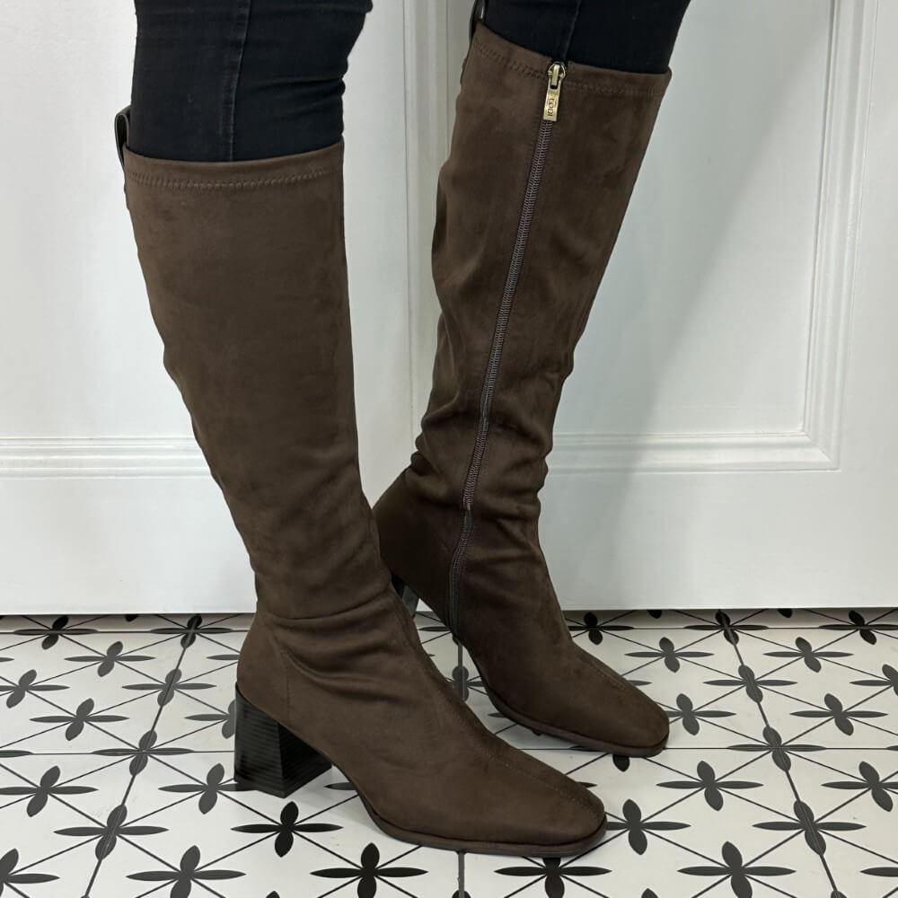 Brown knee-high boots worn indoors on a patterned floor.  LODI A-HALBOR knee high boots Brown