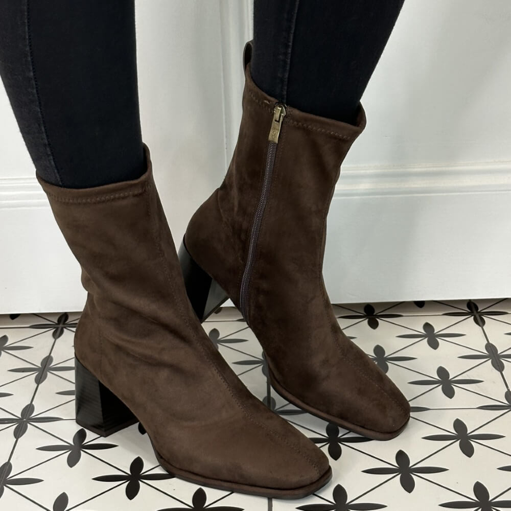 Brown suede ankle boots with block heels on a patterned floor. Lodi A-Heka Ankle Boot Testa Brown