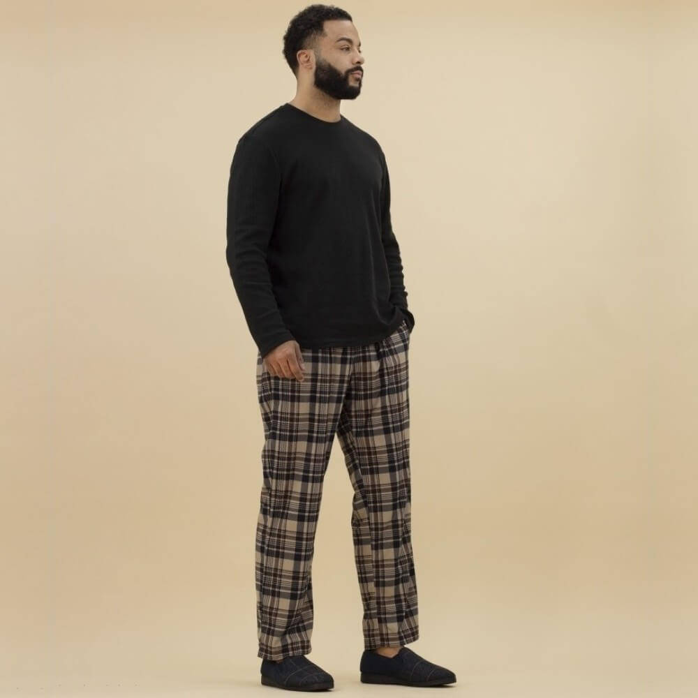 Man in Pj's wearing blue slippers