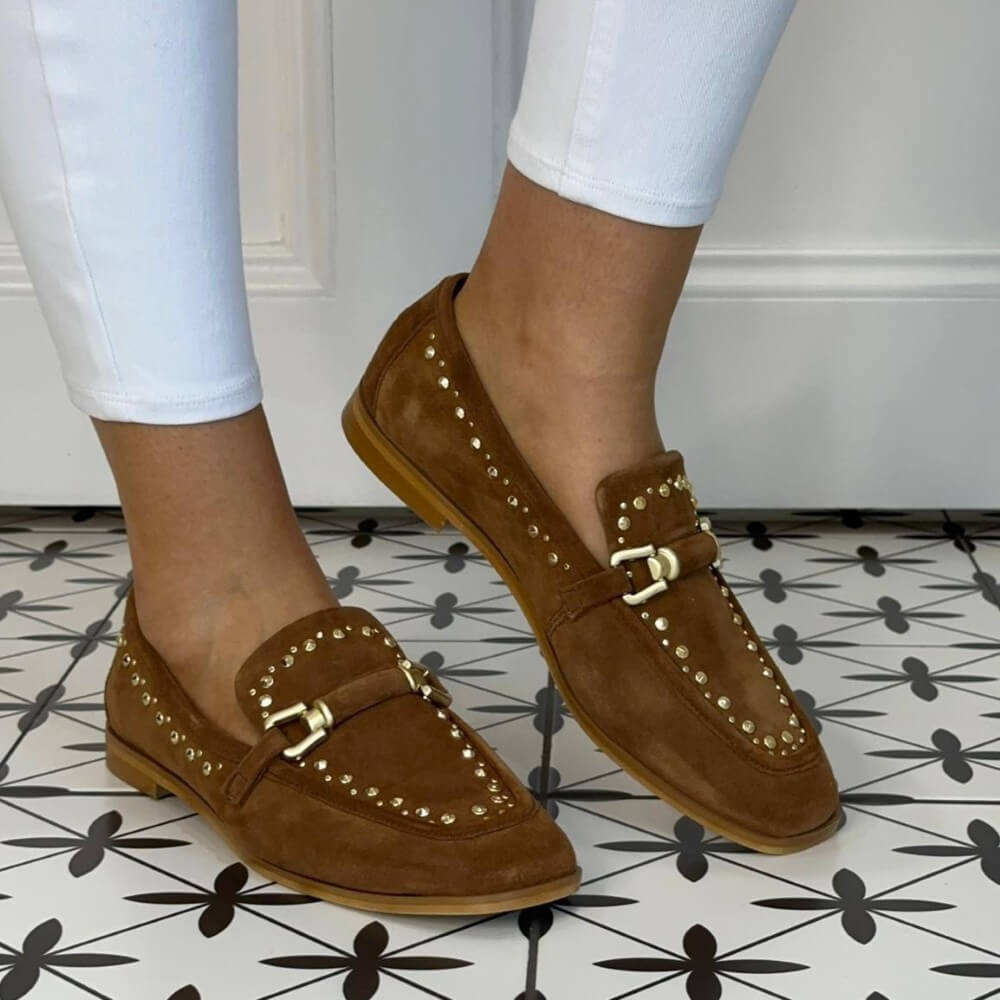 MJUS Tan Suede Loafers with studs worn on a tiled floor